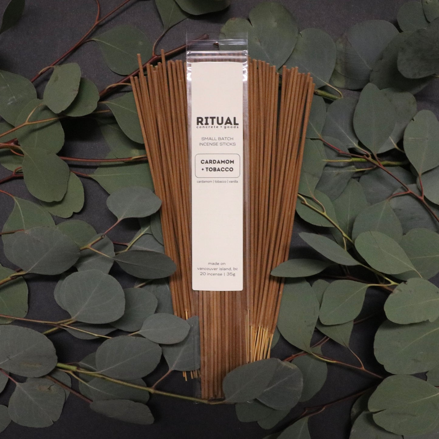 Ritual incense sticks packaging with eucalyptus leaves on a dark background