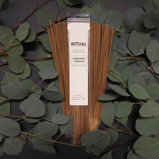 Ritual incense sticks packaging with eucalyptus leaves on a dark background