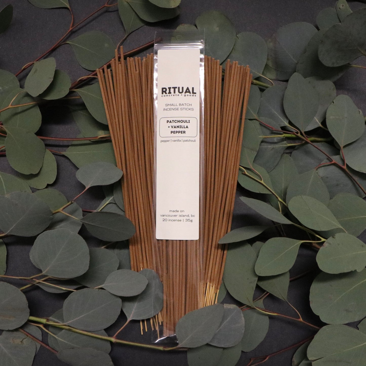 Ritual incense sticks with packaging on a dark background with eucalyptus leaves