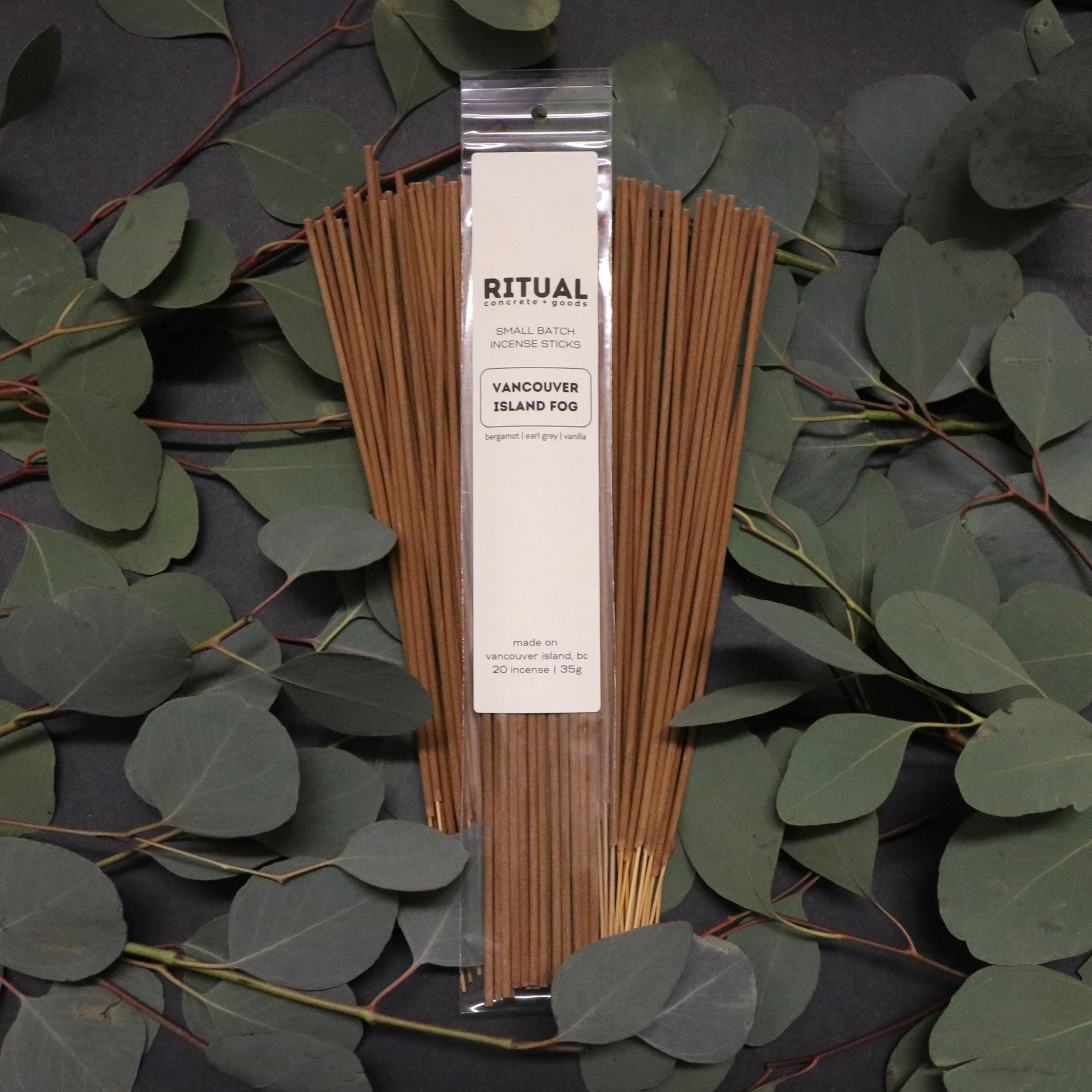 Pack of Ritual Vancouver Island Fog incense sticks on a dark background with eucalyptus leaves.